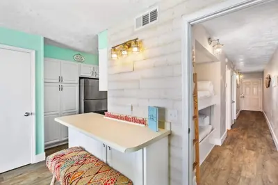 a kitchen with white cabinets and a counter top at The Summit 1322 in Panama City Beach