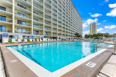 a swimming pool in front of a large apartment building at The Summit 1322 in Panama City Beach