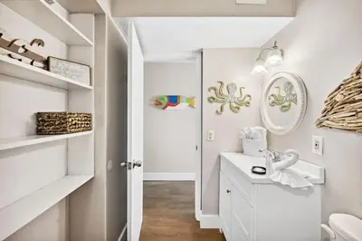 a white bathroom with a sink and a toilet at The Summit 1322 in Panama City Beach