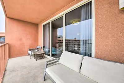 a living room with a couch and a large window at Oceanfront PCB Resort Condo with Balcony and Views! in Panama City Beach
