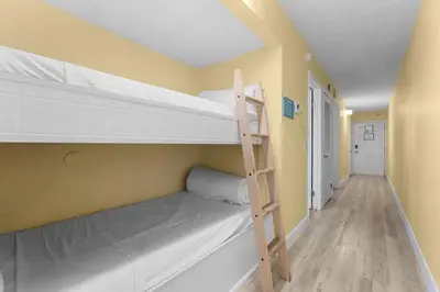 a room with two bunk beds and a ladder at The Summit 726 in Panama City Beach