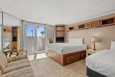a hotel room with two beds and a couch at Top Of The Gulf 111 in Panama City Beach