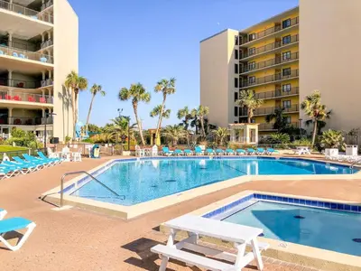 a swimming pool with lounge chairs and a hotel at Top Of The Gulf 111 in Panama City Beach