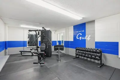 a fitness room with a gym with weights at Top Of The Gulf 111 in Panama City Beach