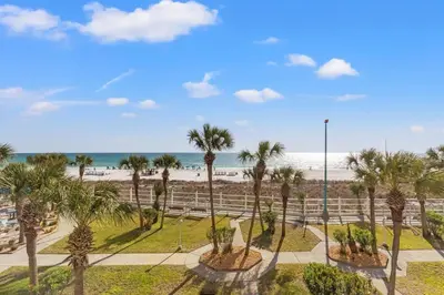 a view of the beach and palm trees at The Summit 306 in Panama City Beach