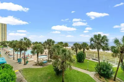a view of the beach from the balcony of a resort at The Summit 306 in Panama City Beach