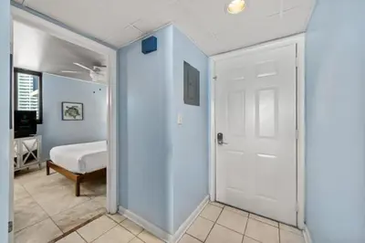 a bedroom with a white door and a bed at Sunbird 811E in Panama City Beach