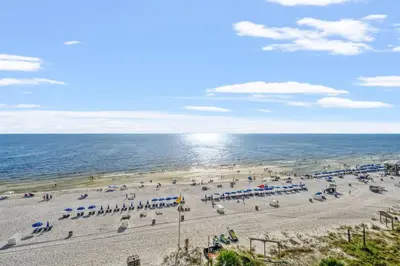 an overhead view of a beach with umbrellas and the ocean at Sunbird 811E in Panama City Beach