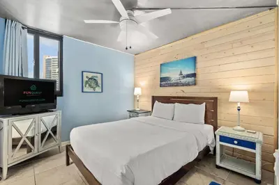 a bedroom with a bed and a flat screen tv at Sunbird 811E in Panama City Beach