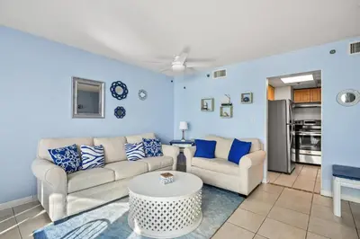 a living room with two couches and a table at Sunbird 811E in Panama City Beach