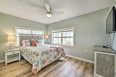 a bedroom with a bed and a ceiling fan at Breezy PCB Retreat with Direct Beach Access! in Panama City Beach