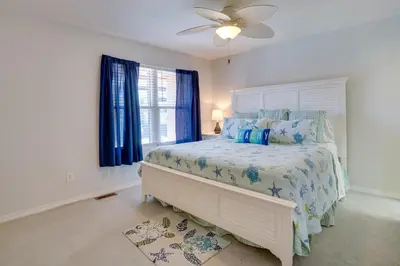 a bedroom with a bed and a ceiling fan at Sun-Dappled PCB Retreat with Multiple Pools! in Panama City Beach