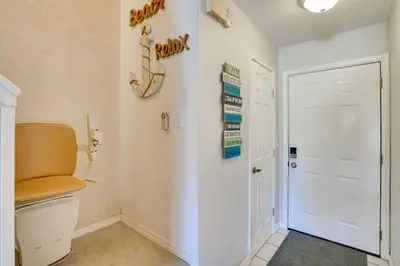 a bathroom with a toilet and a white door at Sun-Dappled PCB Retreat with Multiple Pools! in Panama City Beach