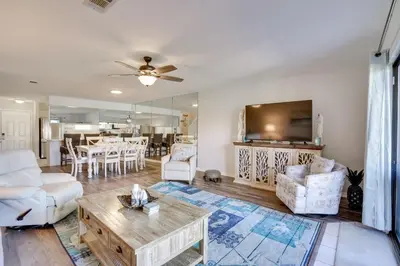 a living room with a couch and a table at Sun-Dappled PCB Retreat with Multiple Pools! in Panama City Beach