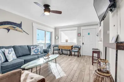 a living room with a couch and a table at Sand Castles West II G4- FinView in Panama City Beach