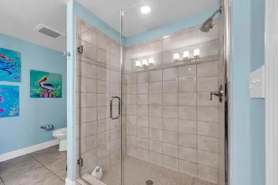 a shower with a glass door in a bathroom at Sterling Breeze 904 in Panama City Beach