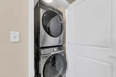 a microwave and a washing machine in a room at Sterling Breeze 904 in Panama City Beach