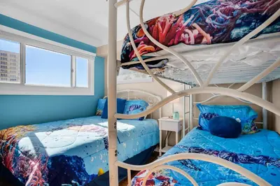 a bedroom with two bunk beds and a bed at The Summit 1432 in Panama City Beach