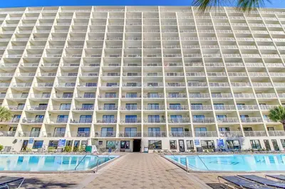 a large building with a pool in front of it at The Summit 1432 in Panama City Beach