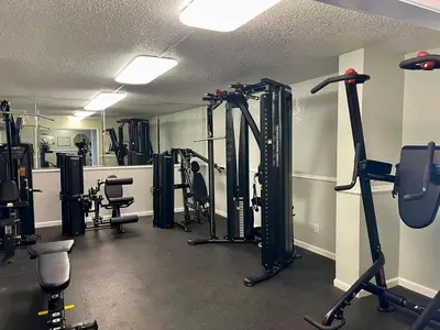 a gym with several treadmills and machines in a room at The Summit 1432 in Panama City Beach