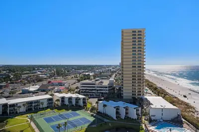 a view of a beach and a tall building with a tennis court at The Summit 1432 in Panama City Beach