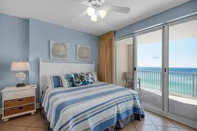 a bedroom with a bed with a view of the ocean at Ocean Villa 1101 in Panama City Beach