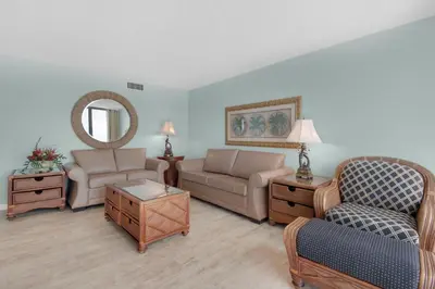 a living room with a couch and a chair at Edgewater Tower 2-307 in Panama City Beach