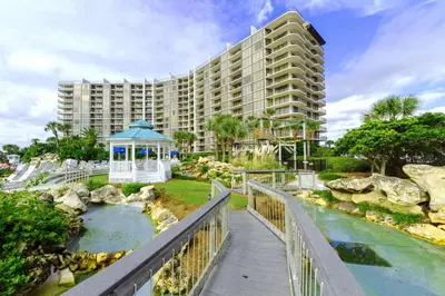a resort with a bridge over a river with a gazebo at Edgewater Tower 2-307 in Panama City Beach