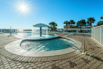 a swimming pool with a water fountain at Majestic Beach Towers 1-1706 in Panama City Beach