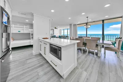 a kitchen and dining room with a view of the ocean at Edgewater Tower 2-407 in Panama City Beach