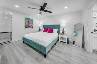 a bedroom with a large bed with pink pillows at Edgewater Tower 2-407 in Panama City Beach