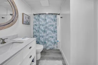 a bathroom with a toilet and a sink and a mirror at Edgewater Tower 2-407 in Panama City Beach