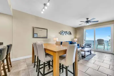 a dining room with a table and a view of the ocean at Sterling Breeze 802 in Panama City Beach