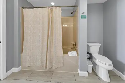a bathroom with a shower curtain and a toilet at Splash 1802E in Panama City Beach