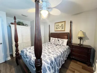 a bedroom with a bed and a ceiling fan at Sterling Beach #602 in Panama City Beach