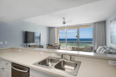 a kitchen with a sink and a view of the ocean at Majestic Beach Towers 1-314 in Panama City Beach