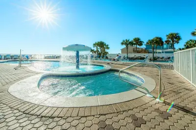 a swimming pool with a water fountain at Majestic Beach Towers 1-314 in Panama City Beach