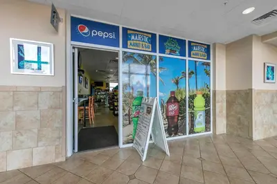 a restaurant with a sign in the front of a store at Majestic Beach Towers 1-314 in Panama City Beach