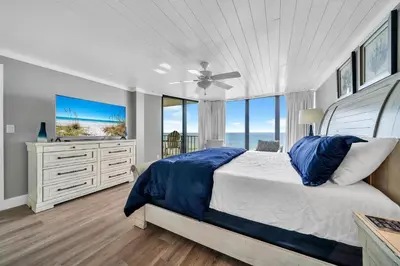 a bedroom with a bed and a large window at Edgewater Tower 3-412 in Panama City Beach