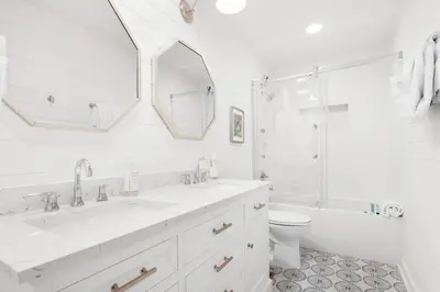a white bathroom with a sink and a toilet at SeaRenity at Inlet 2 in Panama City Beach