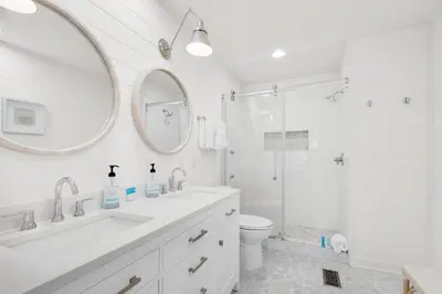 a white bathroom with a sink and a shower at SeaRenity at Inlet 2 in Panama City Beach