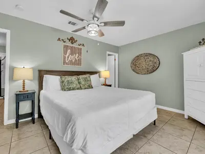 a bedroom with a bed and a ceiling fan at Cassine Gardens 108- Sandy Daze in Santa Rosa Beach