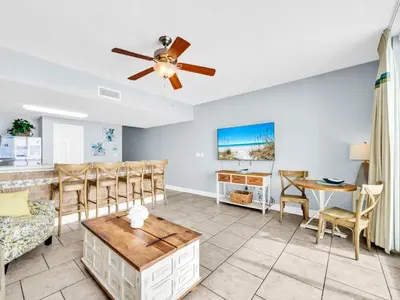 a living room with a ceiling fan and a dining room at Majestic Beach Towers 1-2314 in Panama City Beach