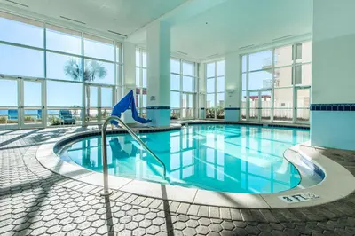a swimming pool in a building with windows at Majestic Beach Towers 1-2314 in Panama City Beach