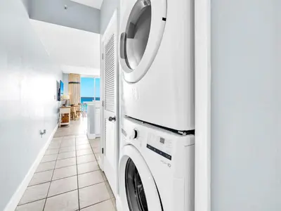 a washer and dryer in a white laundry room at Majestic Beach Towers 1-2314 in Panama City Beach