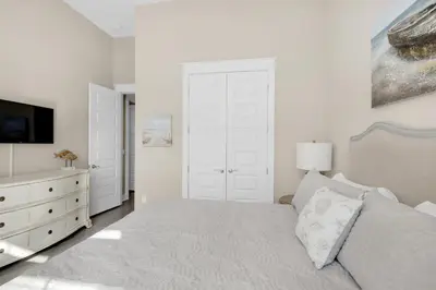 a white bedroom with a bed and a dresser at Town of Prominence 326B- Seaside Paradise in Santa Rosa Beach