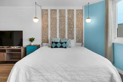 a bedroom with a large bed and a television at Top of the Gulf 713 in Panama City Beach