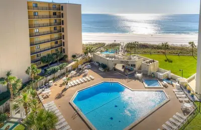 an aerial view of a resort with a swimming pool and the ocean at Top of the Gulf 713 in Panama City Beach