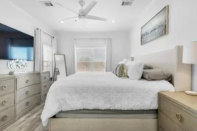 a white bedroom with a bed and a ceiling fan at Legacy 505- Pearl by the Sea in Santa Rosa Beach