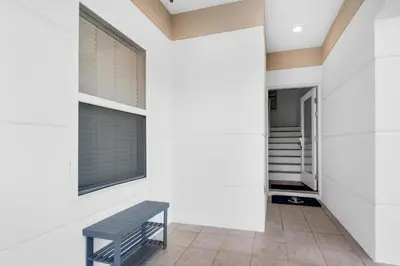 a blue bench in a hallway with a window at Legacy 505- Pearl by the Sea in Santa Rosa Beach